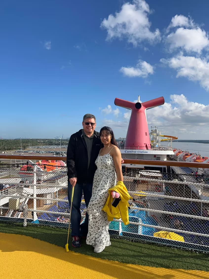 A couple on the top deck of a Carnival cruise ship