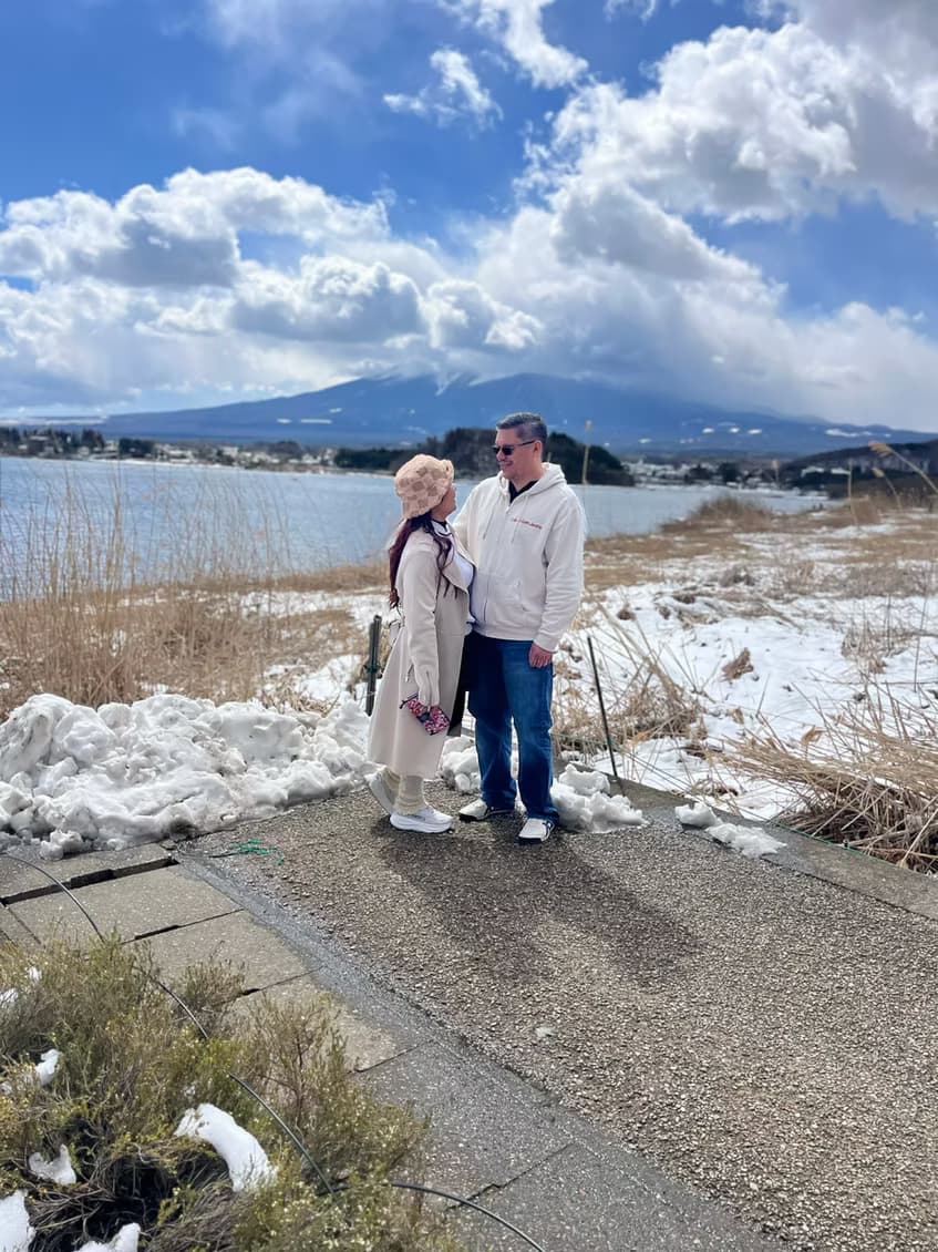 A couple by a lakeside with Mt. Fuji in the background