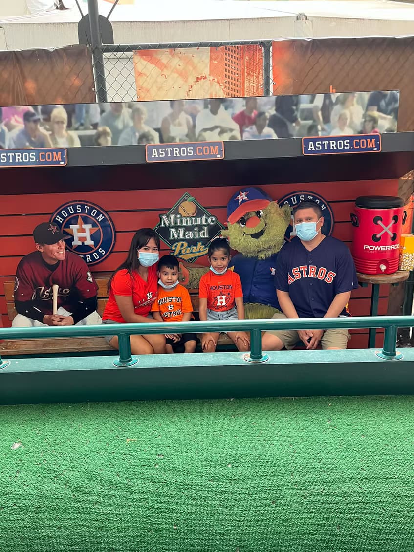 The family posing in the Astros dugout at Minute Maid Park