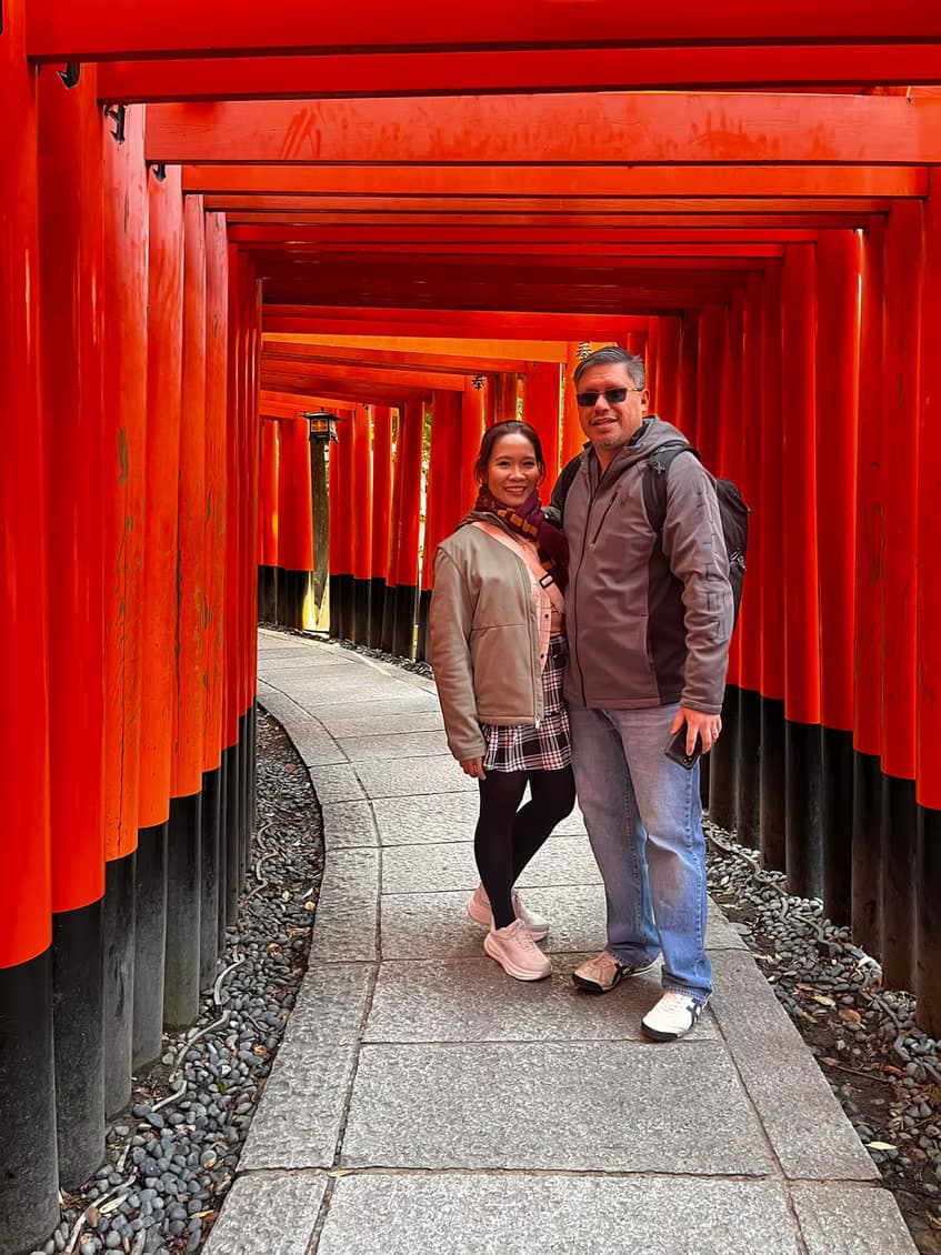 The couple walking the red torii gates at Fushimi Inari in Kyoto