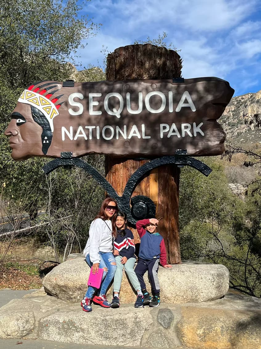 Canyesa and the kids at the Sequoia National Park entrance sign