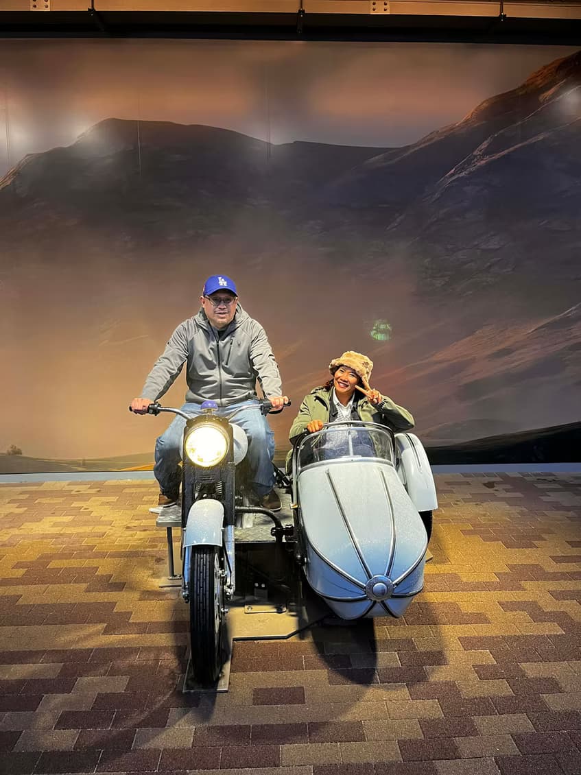 Canyesa and her husband on Hagrid's motorbike and sidecar at Universal Studios