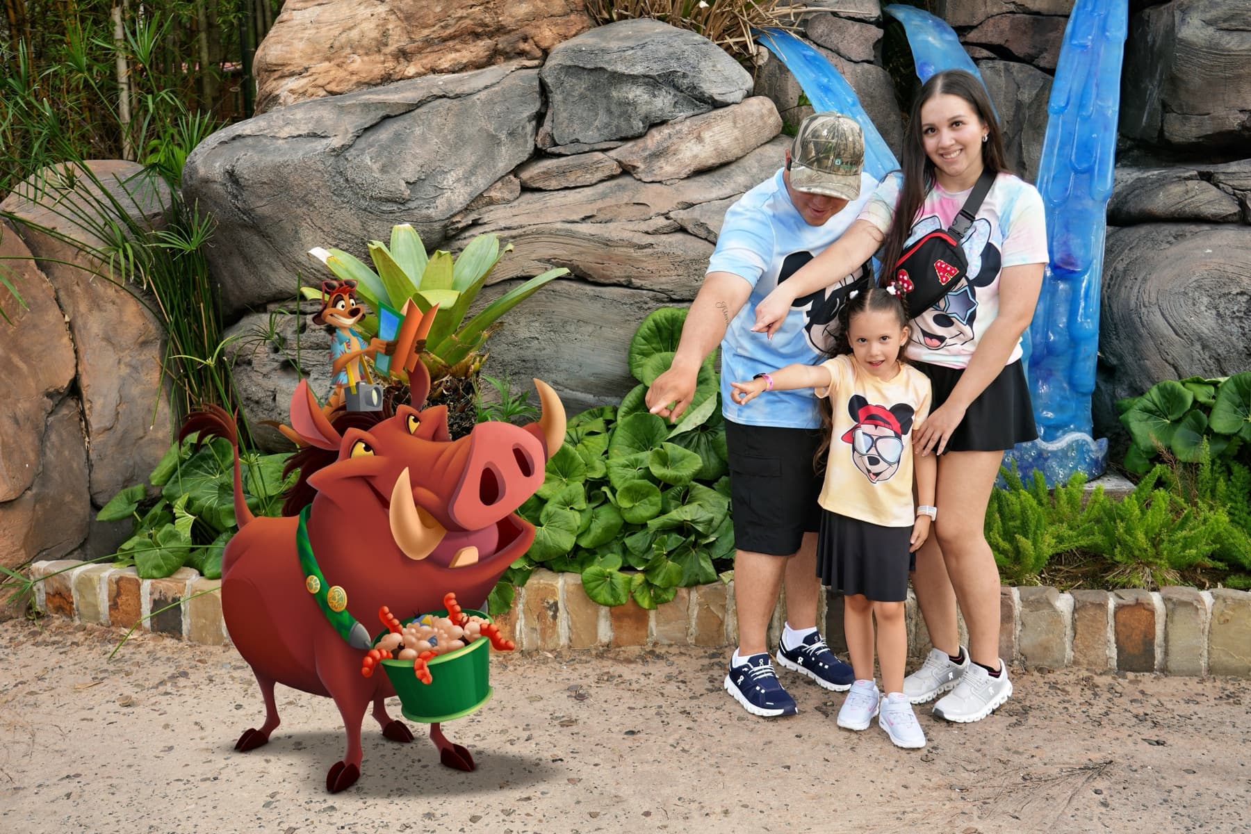 The Garcia family posing with Timon and Pumbaa at Disney's Animal Kingdom